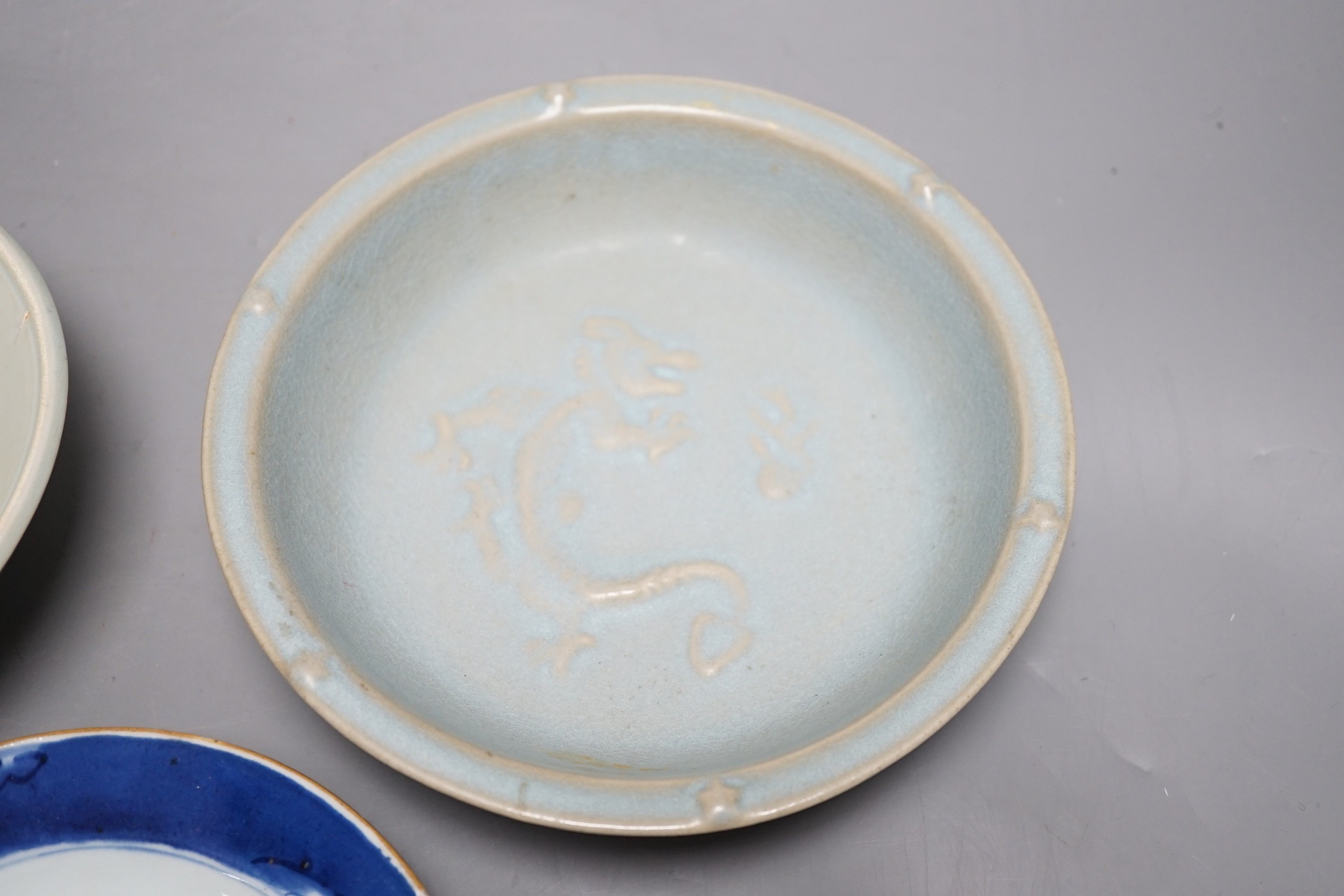 A group of three Chinese ceramics; a Qing Bai style bowl, a Jun style bowl with dragon relief decor and inscription to base, and a blue and white dish, tallest 6cm